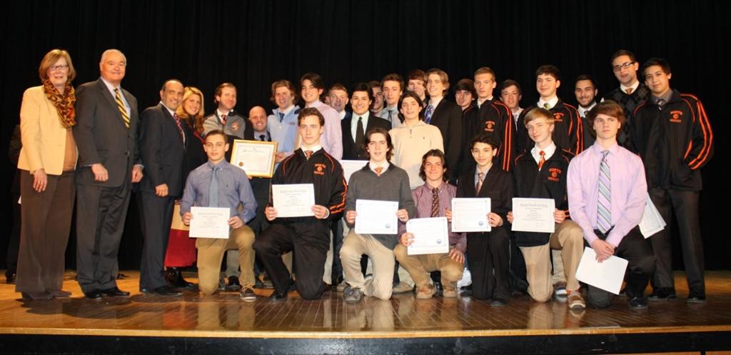 Freeholder John P. Curley, Freeholder Thomas A. Arnone and Freeholder Deputy Director present certificates of recognition to Middletown North High School’s Lions ice hockey team for winning the 2015 Public B State NJSIAA/ Devils Ice Hockey Championship at the Middletown Board of Education meeting on March 24.